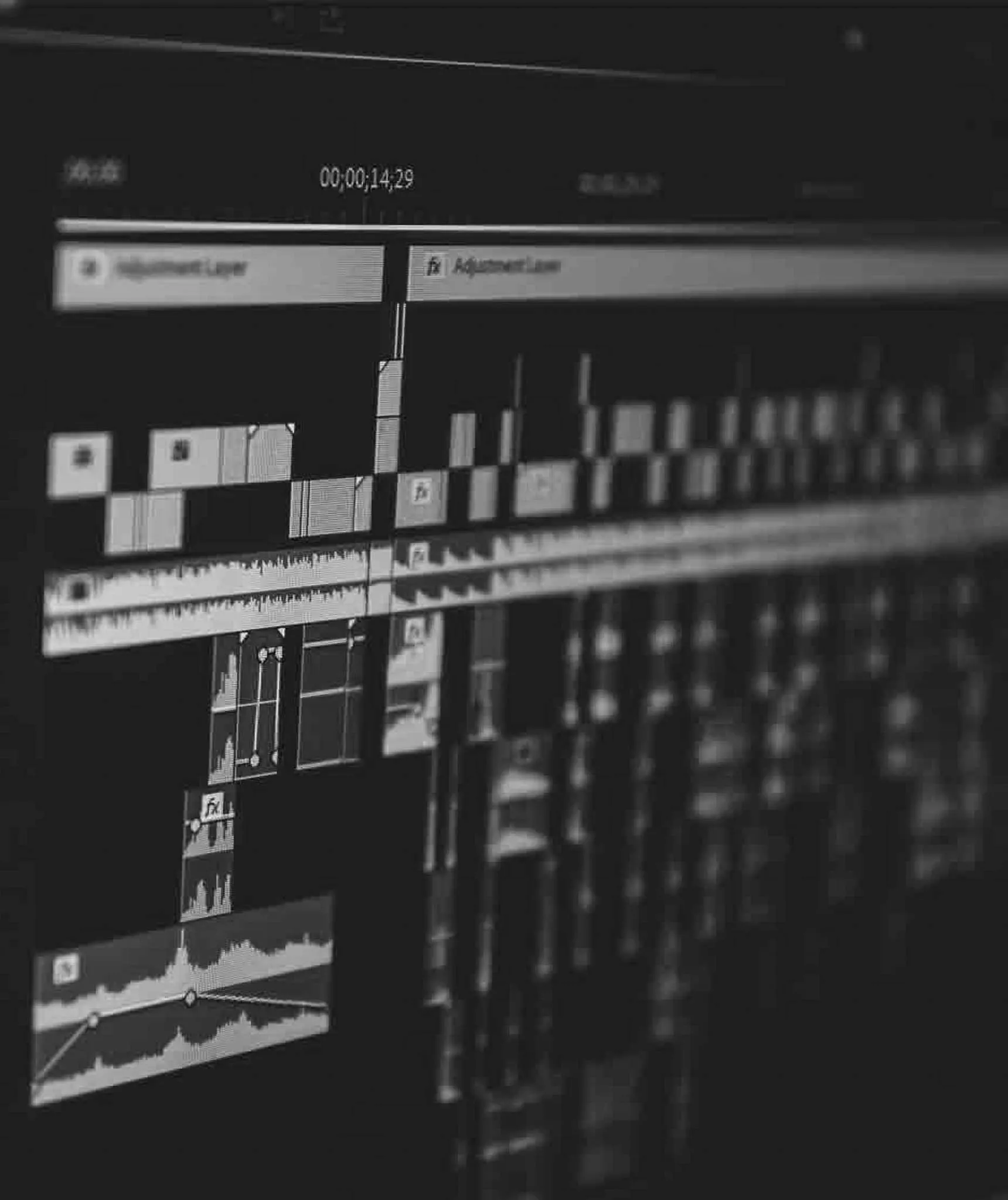 An editor at a multi-screen desk, for the Post Production step