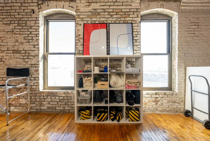 A clothing rack and a brick wall in the Bloom Creativ studio
