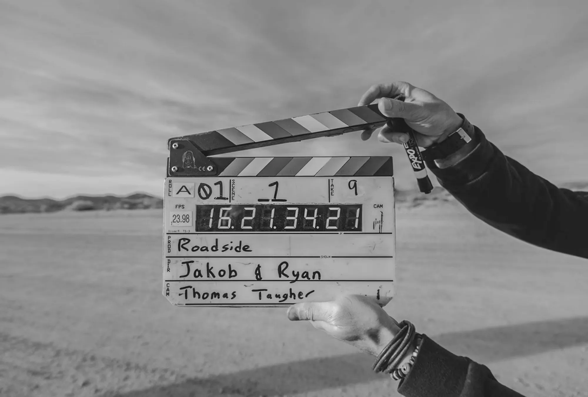 A camera operator filming a person on a set, for the Production step