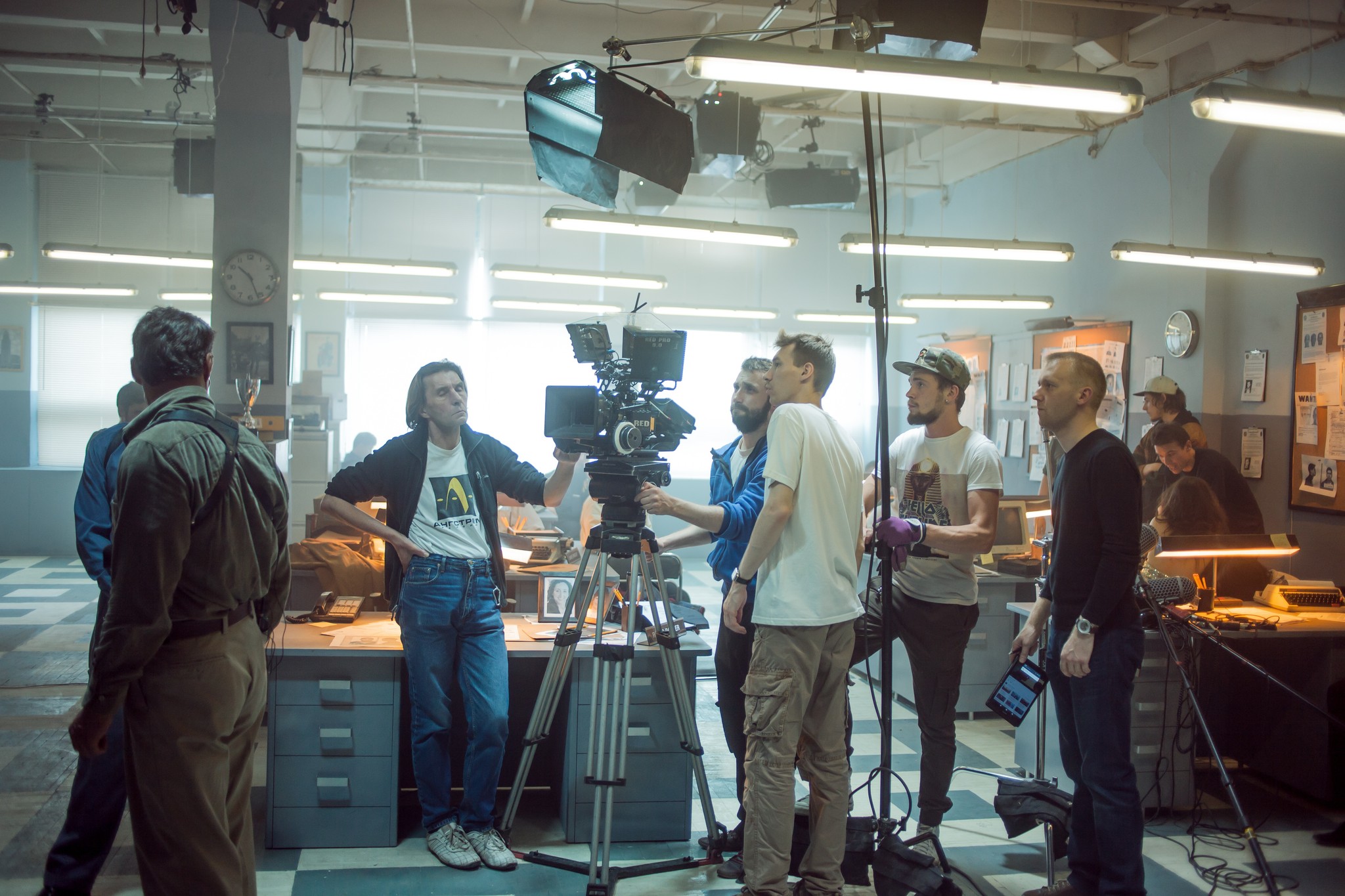 A film crew with cameras and a boom mic on a set