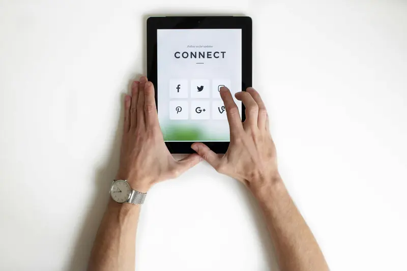 Hands typing on tablet
