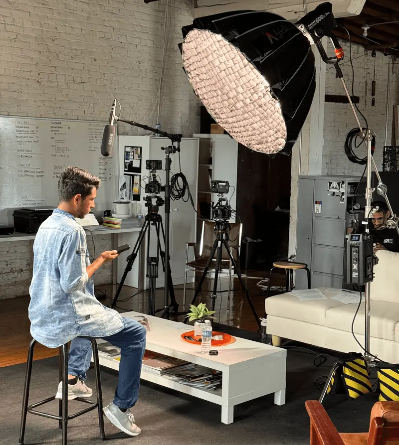 A person speaking to camera in a lit studio, for the corporate video production guide