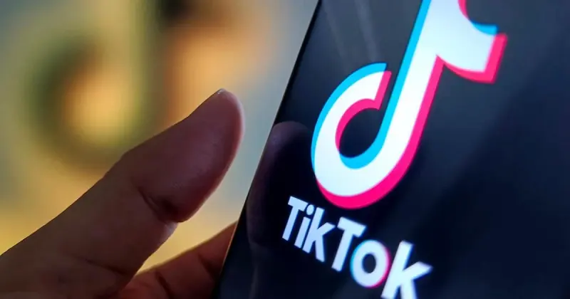 A phone home screen with the TikTok icon