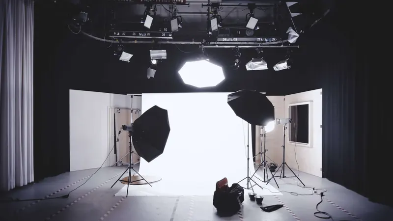 A lighting stand with a softbox in a dark studio