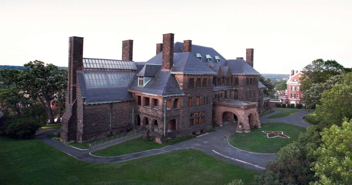 A pink sandstone building with a clock tower, in the Twin Cities filming locations post